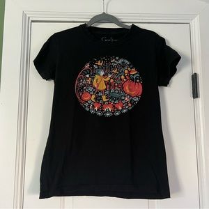 Black t-shirt with Coraline garden art